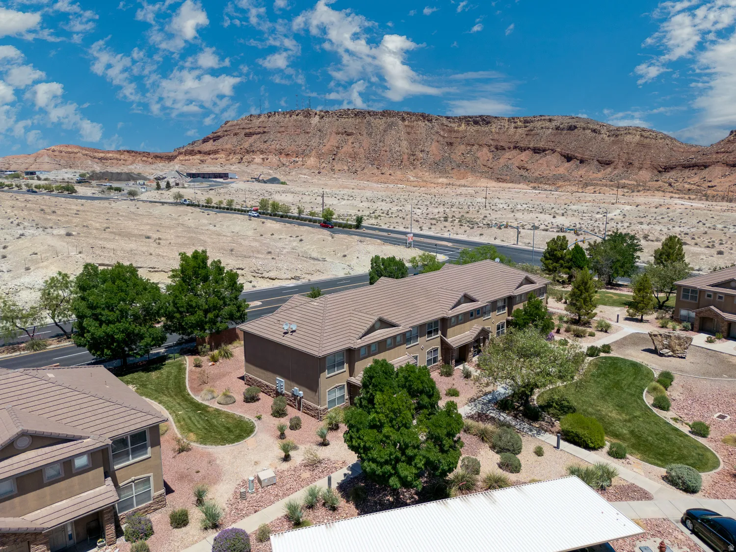 Multi-story residential buildings with tan stucco exteriors and brown tile roofs