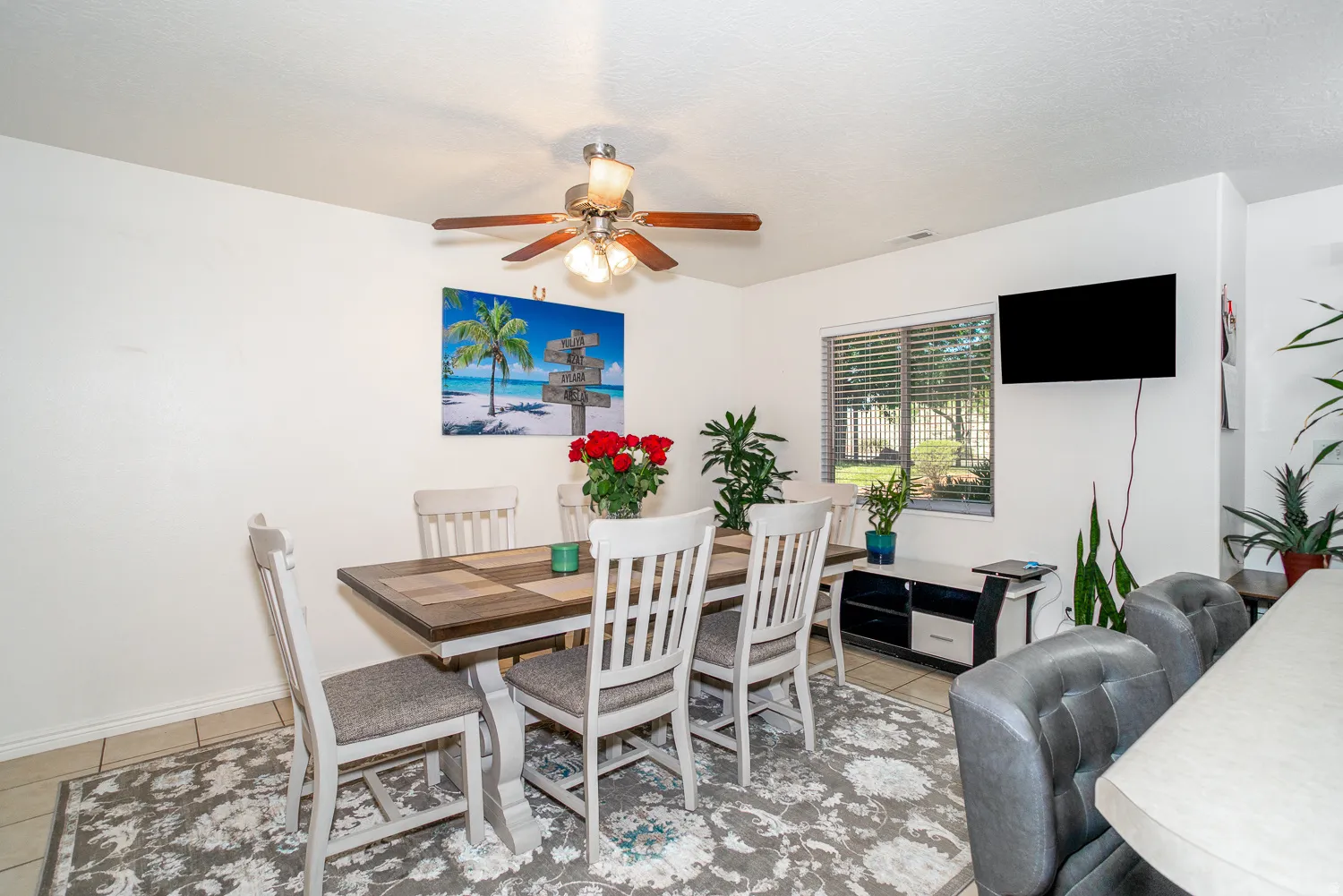 Dining area featuring tile flooring and a ceiling fan with integrated lighting