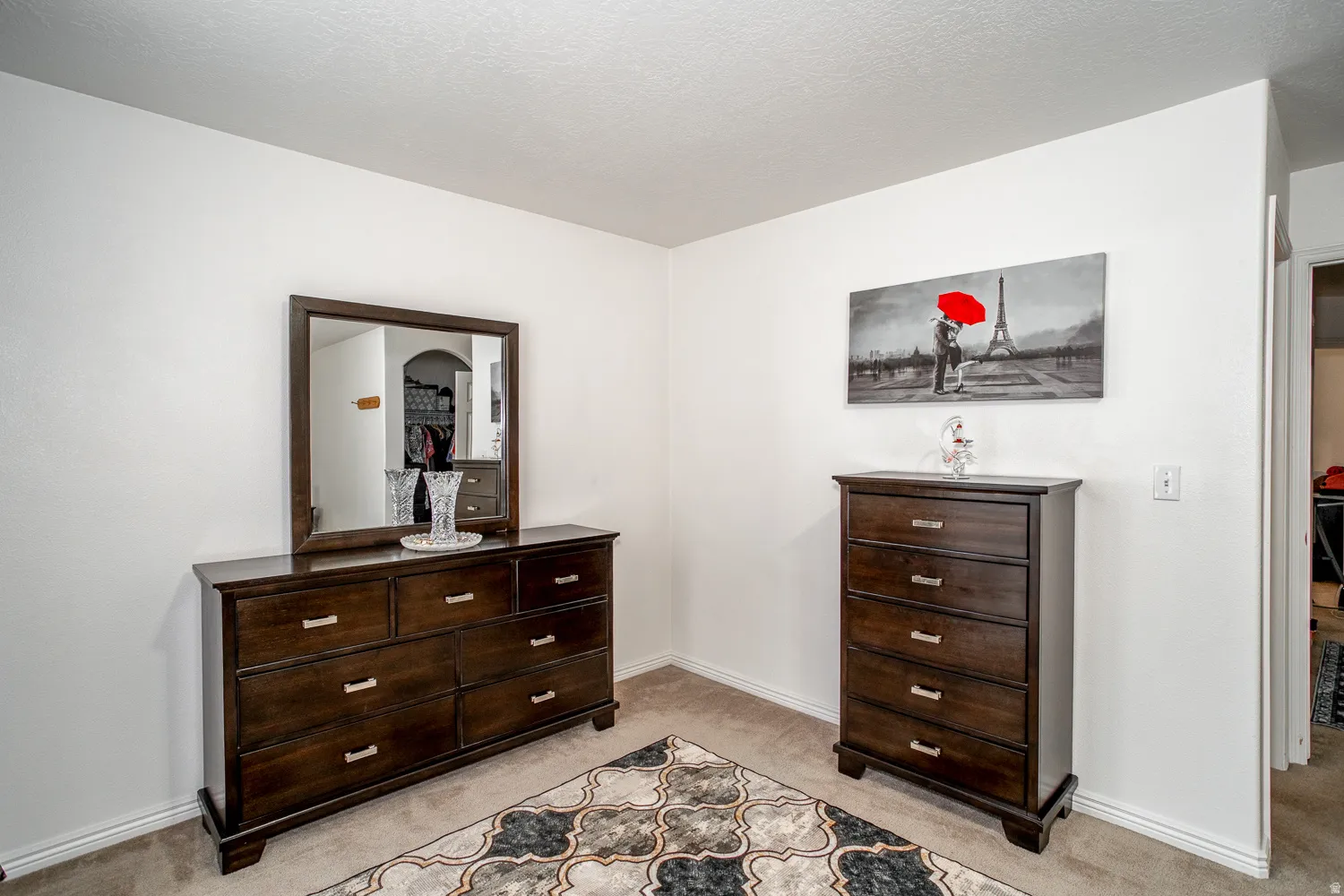 Neutral wall color with a framed wall mirror and carpet flooring