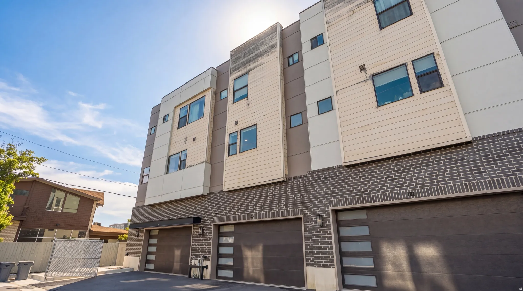Modern multi-level townhome exterior featuring contemporary design elements