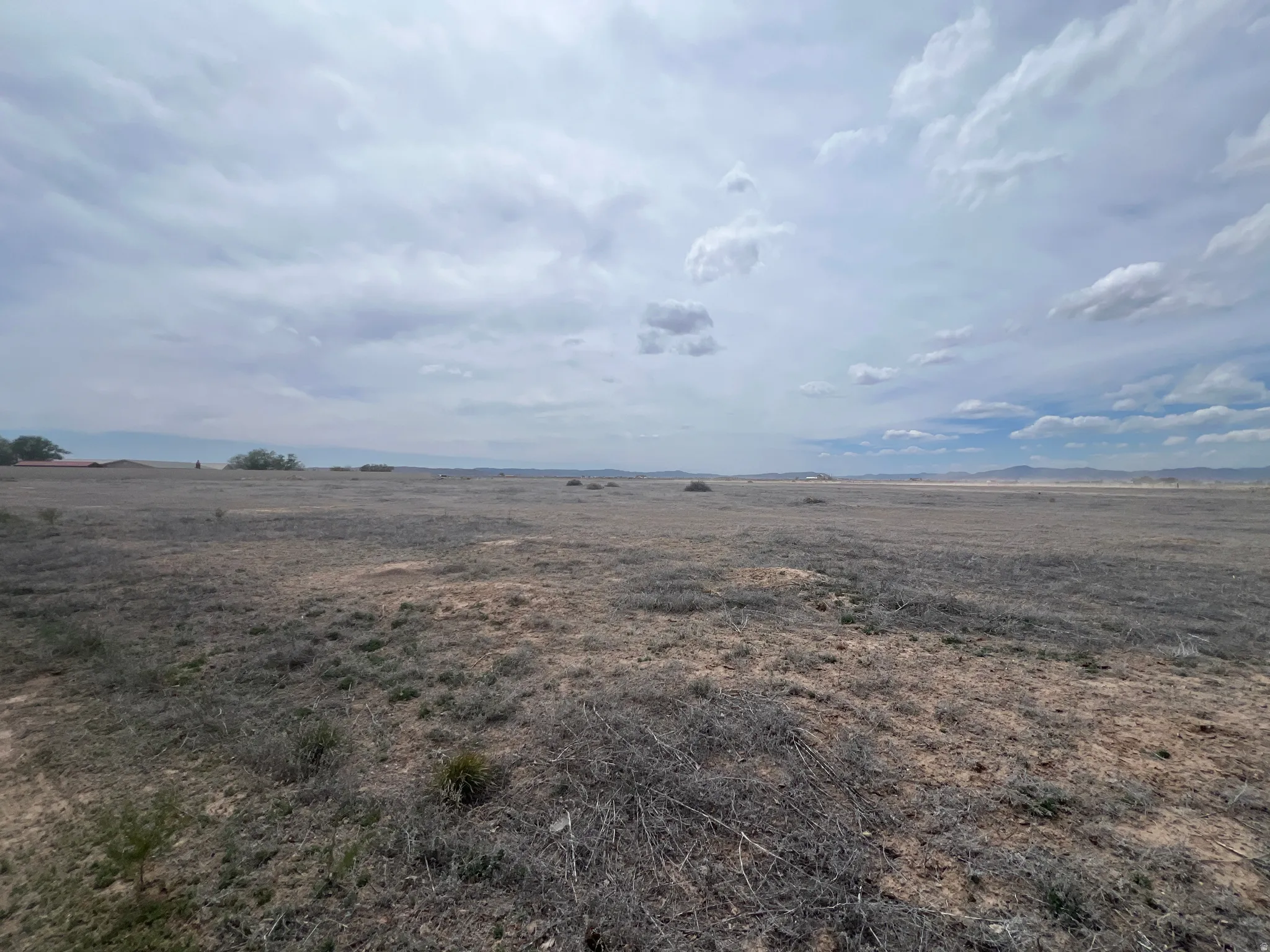 Expansive open land featuring a natural, arid landscape