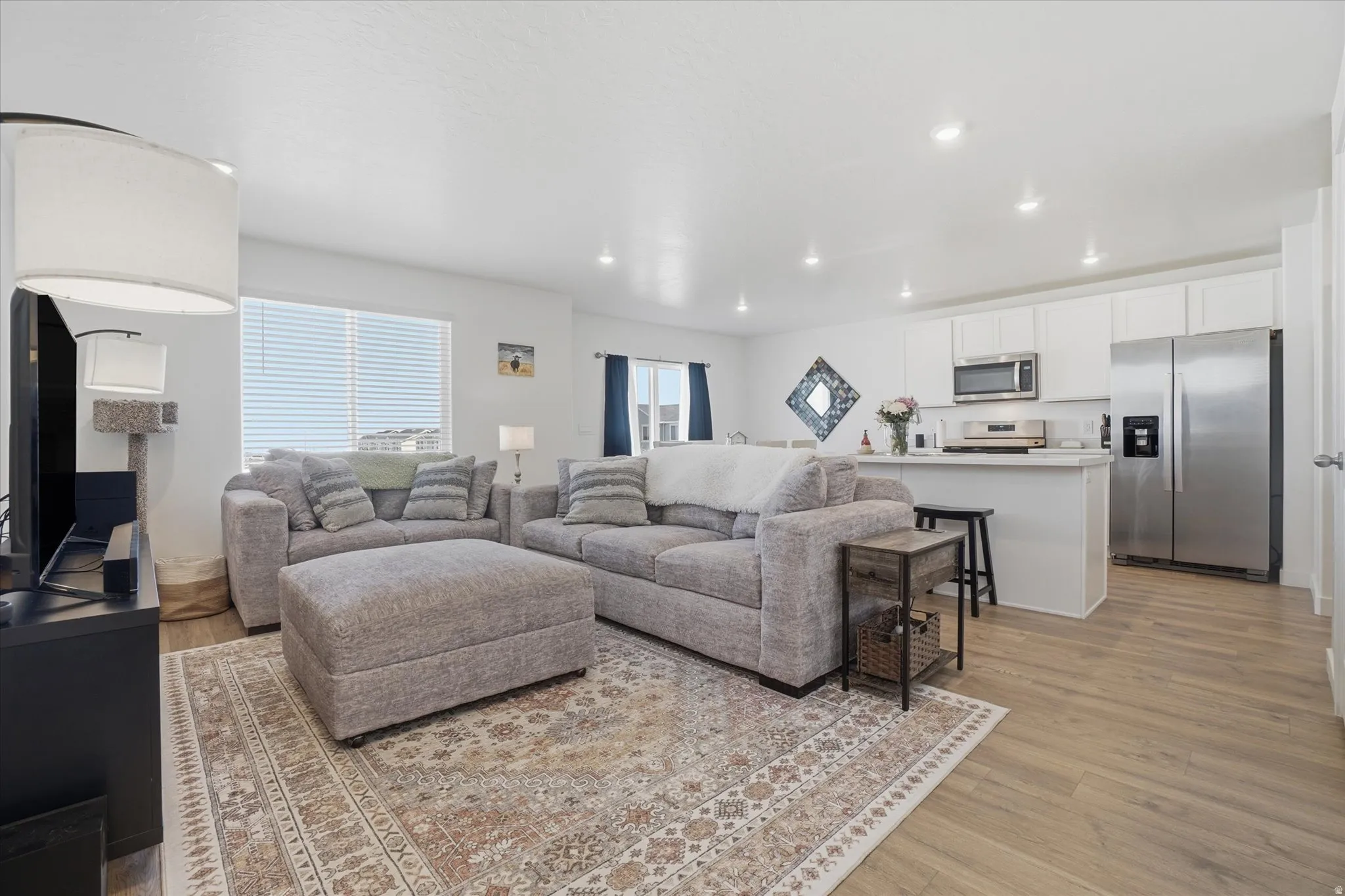 Open-concept living space featuring wood-finish flooring