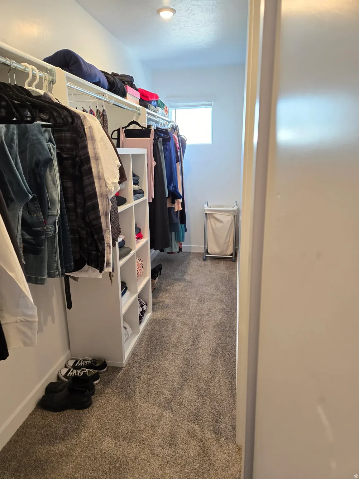 Master Walk-in closet featuring built-in shelving, hanging rods, and recessed lighting