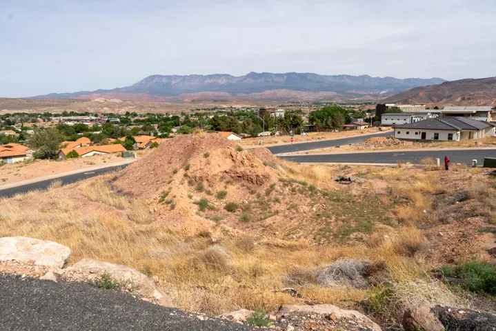 Elevated building lot featuring natural desert landscaping and paved street access