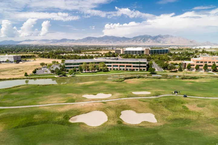 Expansive green space featuring golf course fairways and sand traps
