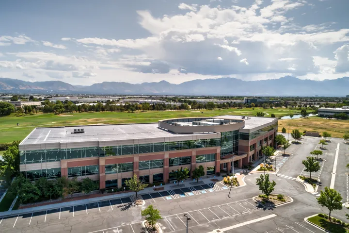 Contemporary building featuring extensive glass curtain walls and mountain scenery