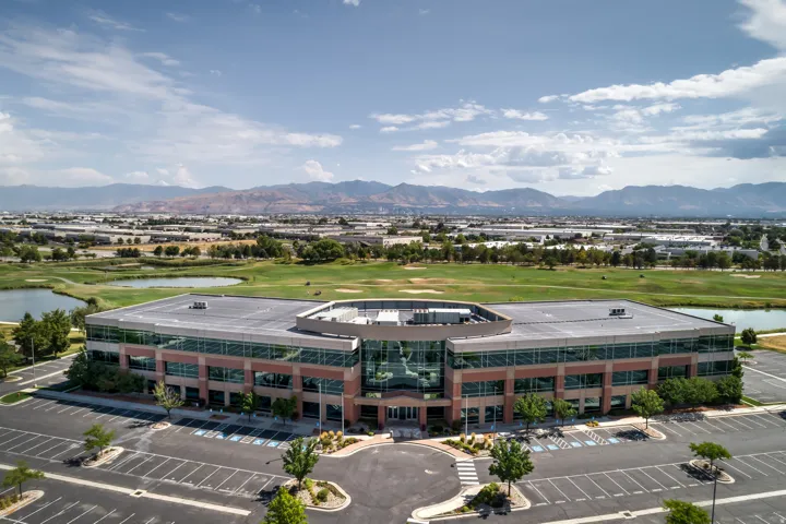 Modern commercial building featuring expansive glass curtain walls and a multi-level structure