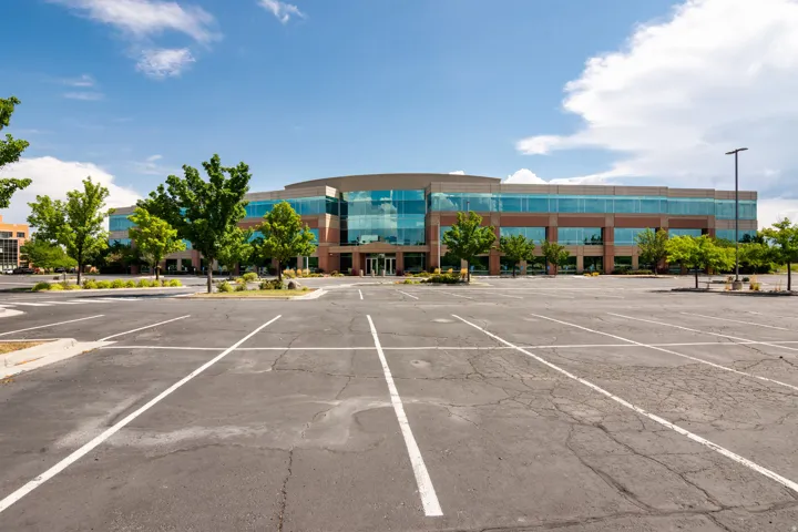 Expansive asphalt parking lot with multiple marked spaces