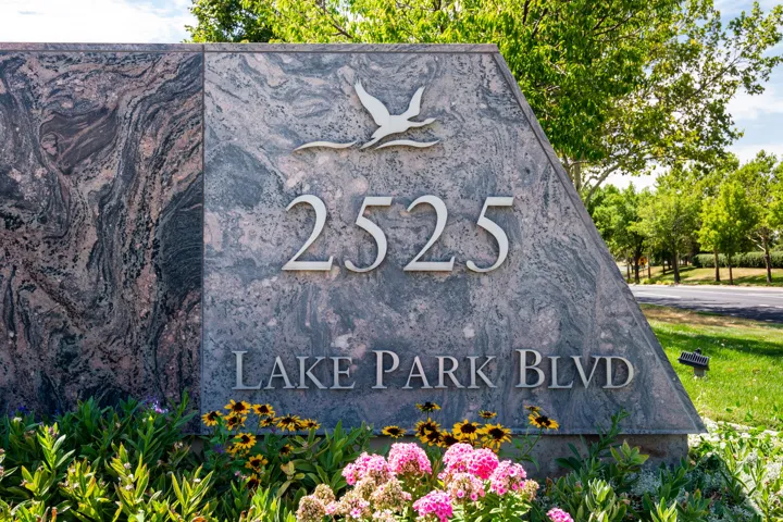 Stone monument signage featuring street address numbers and street name