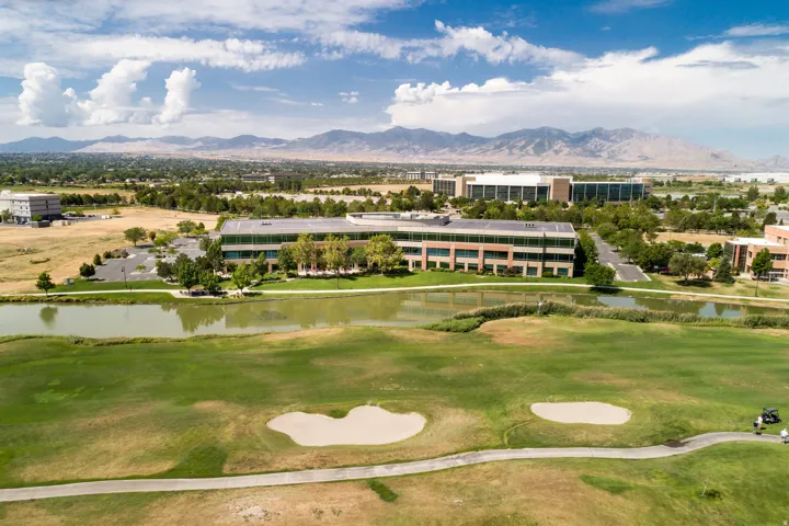 Expansive golf course frontage featuring manicured greens and sand bunkers