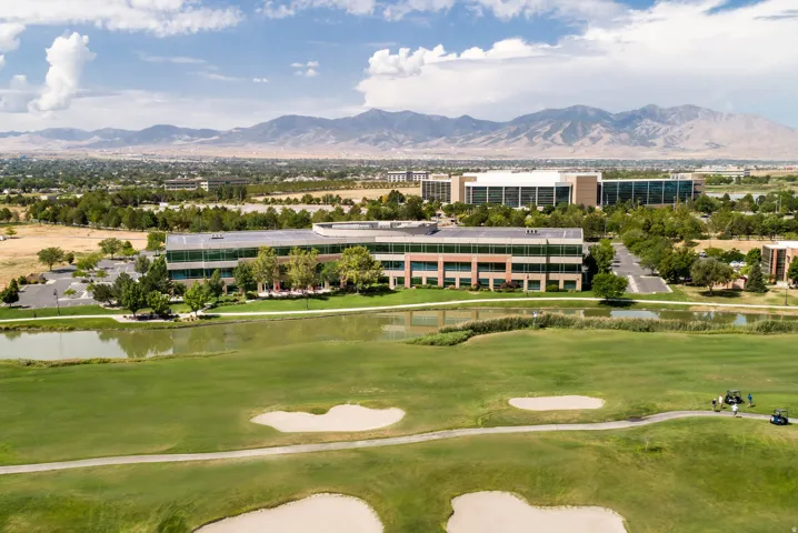 Expansive golf course greens featuring sand traps and a water hazard