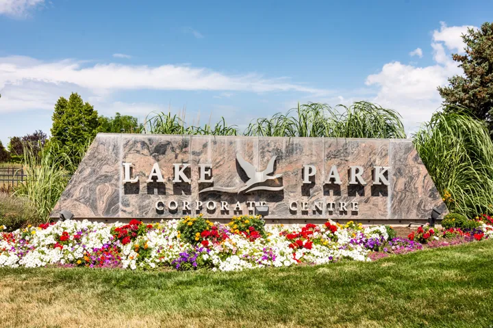 Stone entry monument featuring dimensional lettering, a bird graphic, and integrated landscaping