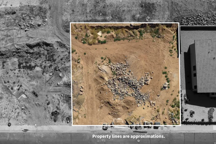 Cleared lot with exposed earth and scattered rock debris
