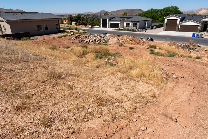 Open land parcel with visible excavation, offering proximity to developed properties