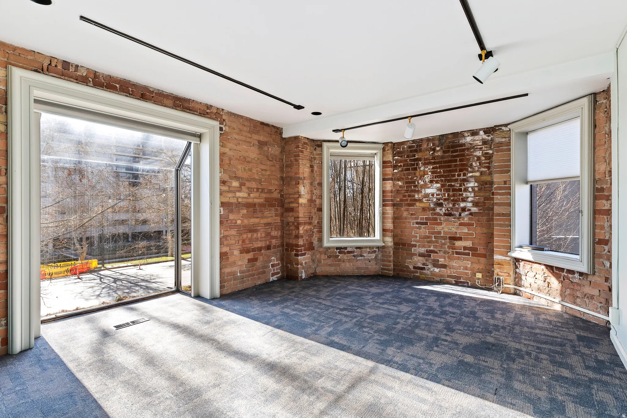 Exposed brick walls defining the space, complemented by a large glass patio door
