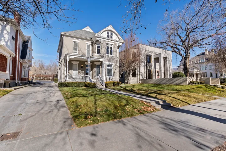 Victorian-style residence featuring a prominent front porch with decorative railings