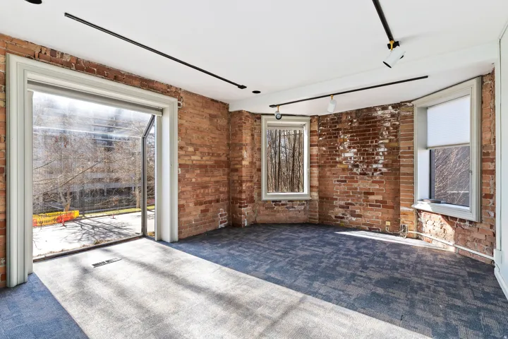 Exposed brick walls defining the space, complemented by a large glass patio door