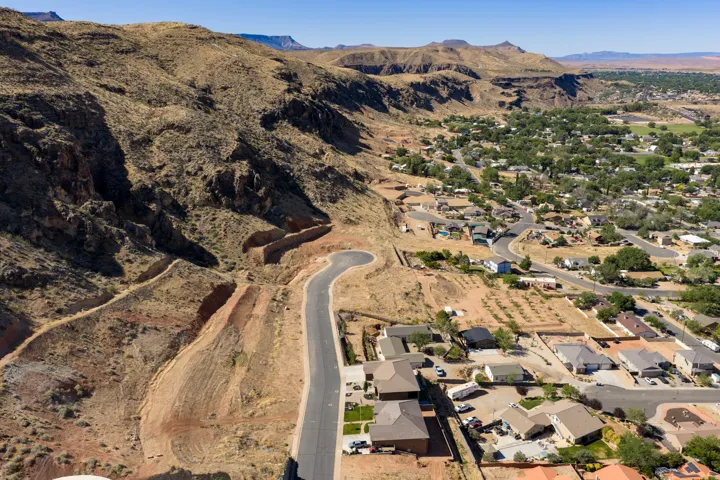 Residential development nestled against a rugged, mountainous landscape
