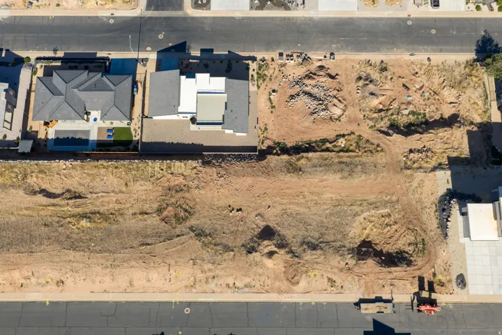 Expansive vacant land parcel featuring undeveloped terrain and existing street access