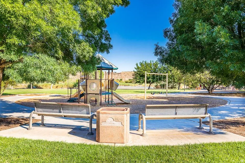 Community park featuring a play structure, swing set, and open green space