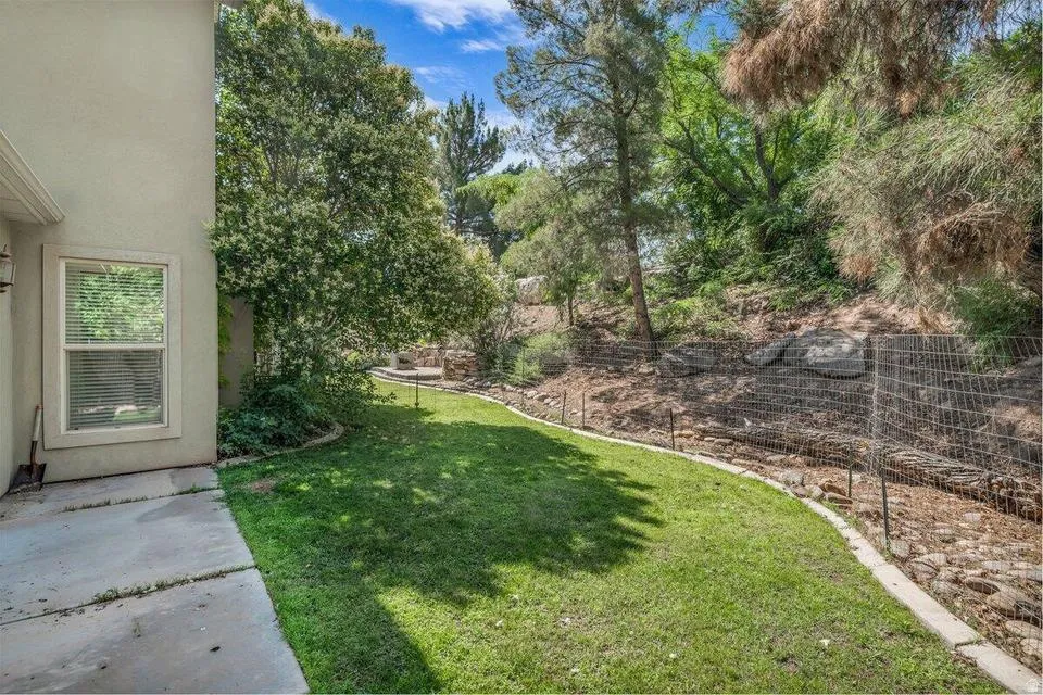 Manicured lawn area with a concrete perimeter strip