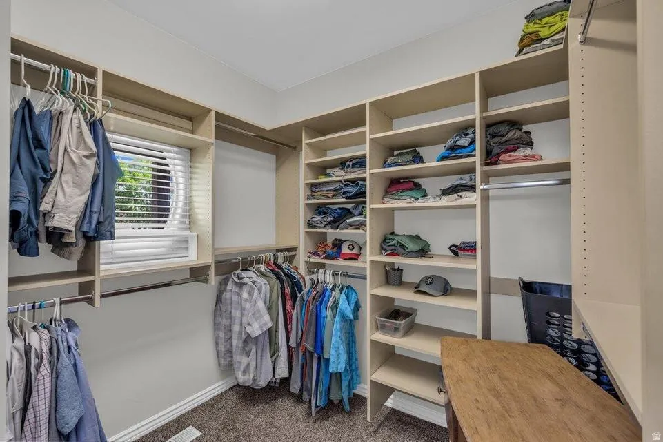 Custom closet system featuring extensive shelving and hanging rods