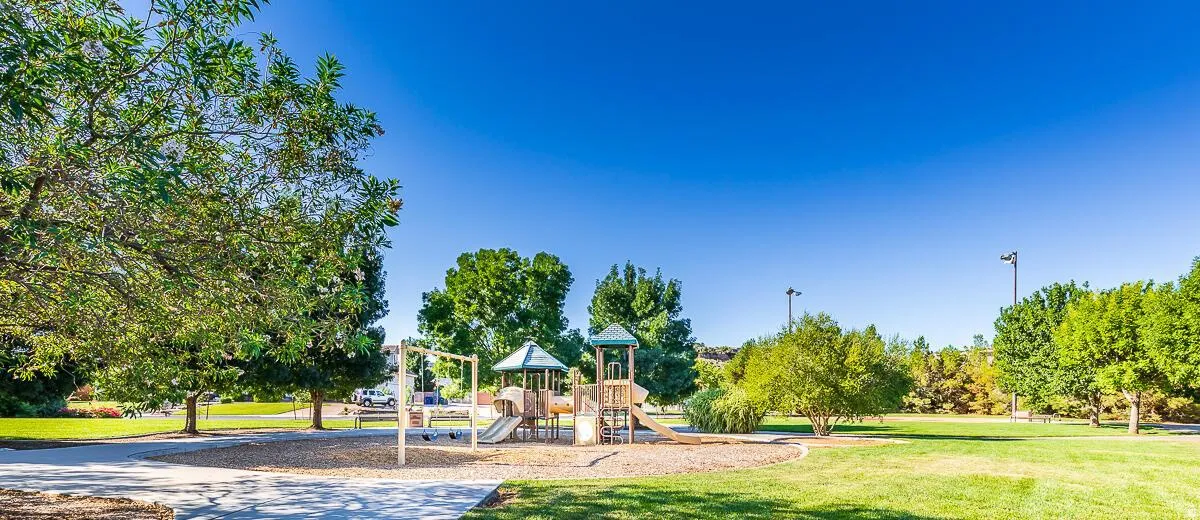 Community park featuring a play structure with slides and swings