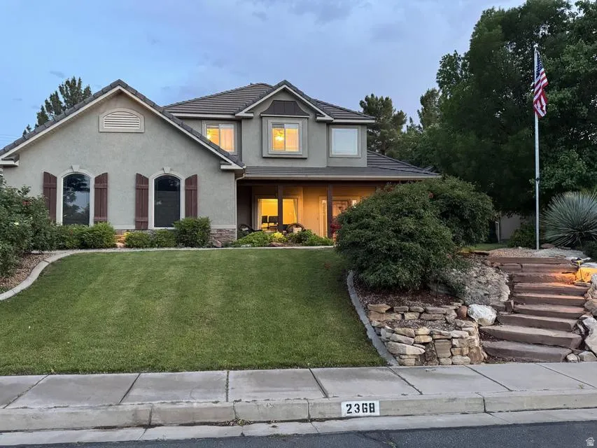 Stucco exterior residence with a tiled roof and stone accents