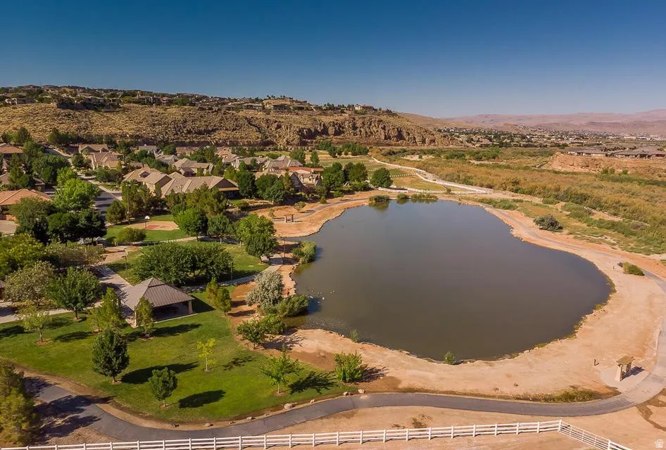 Expansive neighborhood lake featuring natural shoreline and surrounding vegetation