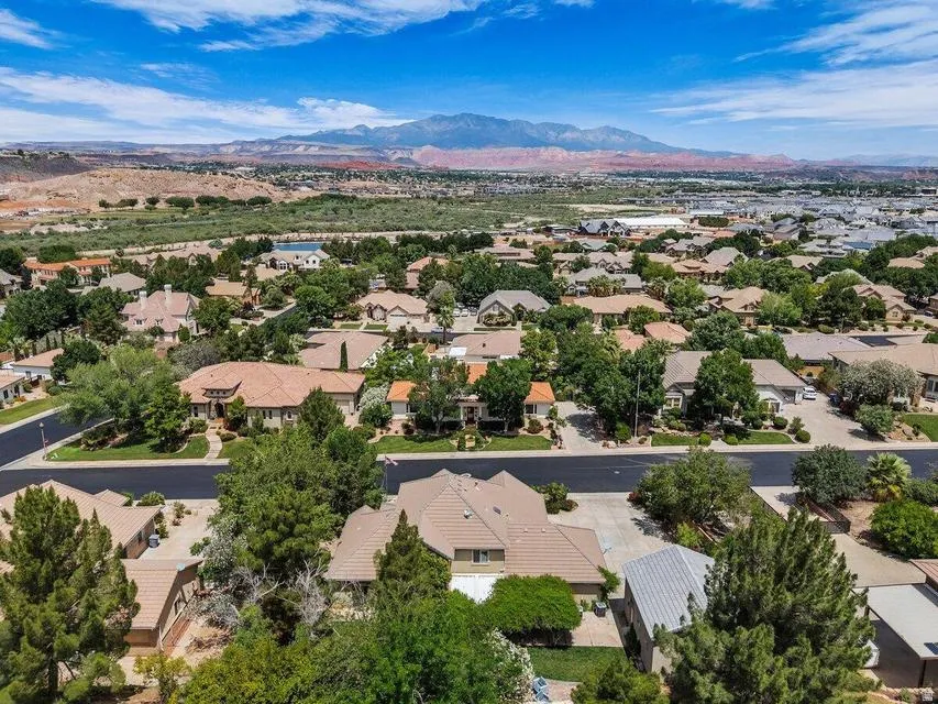 Expansive suburban landscape featuring a collection of homes with tiled roofs and abundant mature trees