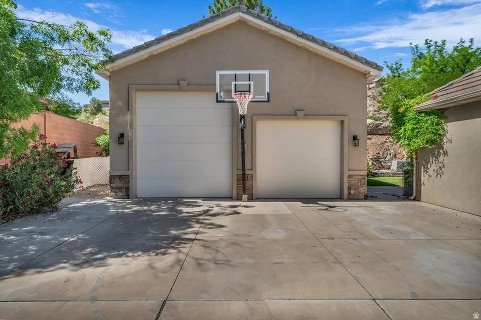 Two-car garage with stucco exterior and stone veneer accents