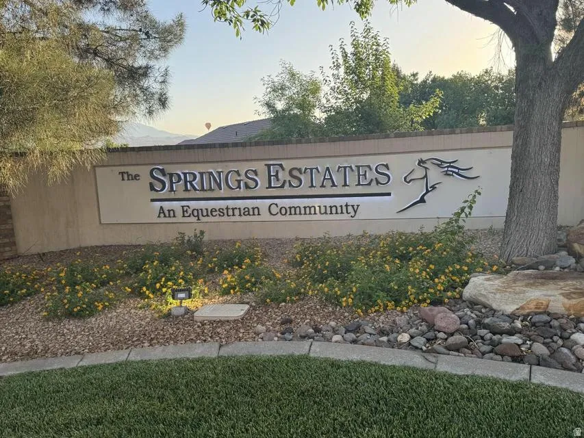 Community entrance sign for "The Springs Estates," featuring an equestrian design motif