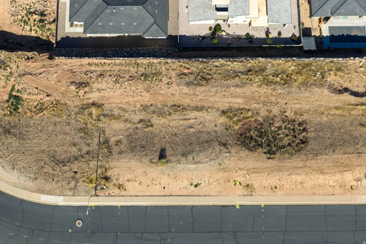 Expansive undeveloped lot with natural desert vegetation, offering a blank canvas for customization
