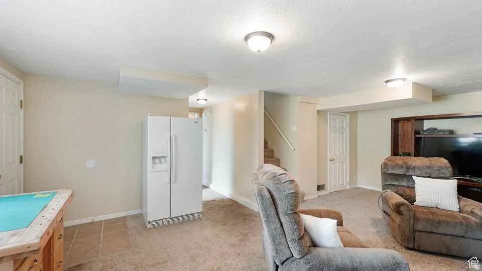 Carpeted lower level with enclosed Cold Storage area
