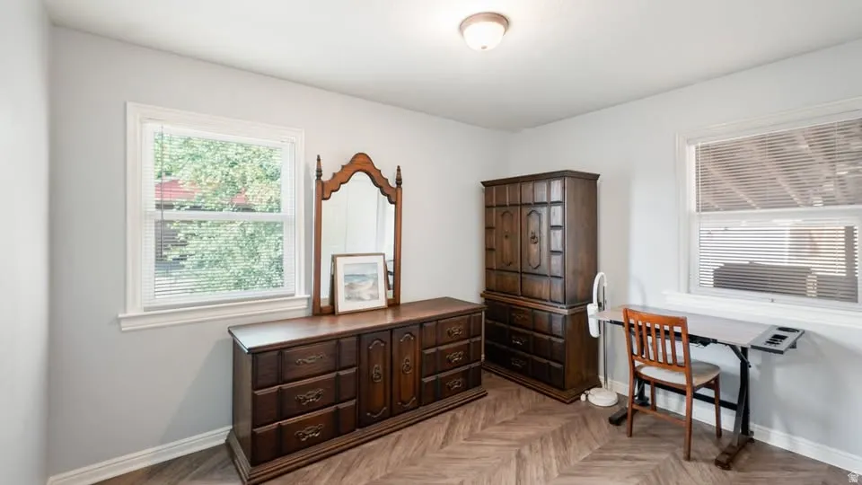 Bright room featuring wood-finish flooring in a herringbone pattern