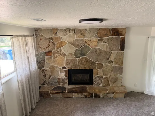 Stone-clad fireplace with a recessed firebox and stone hearth