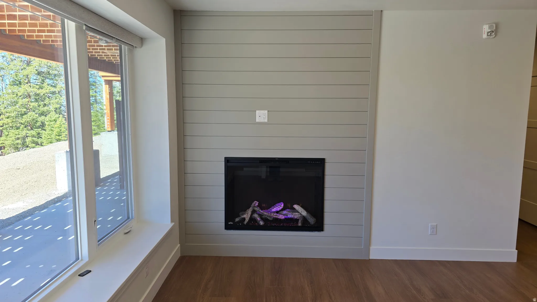 Shiplap accent wall featuring a built-in fireplace