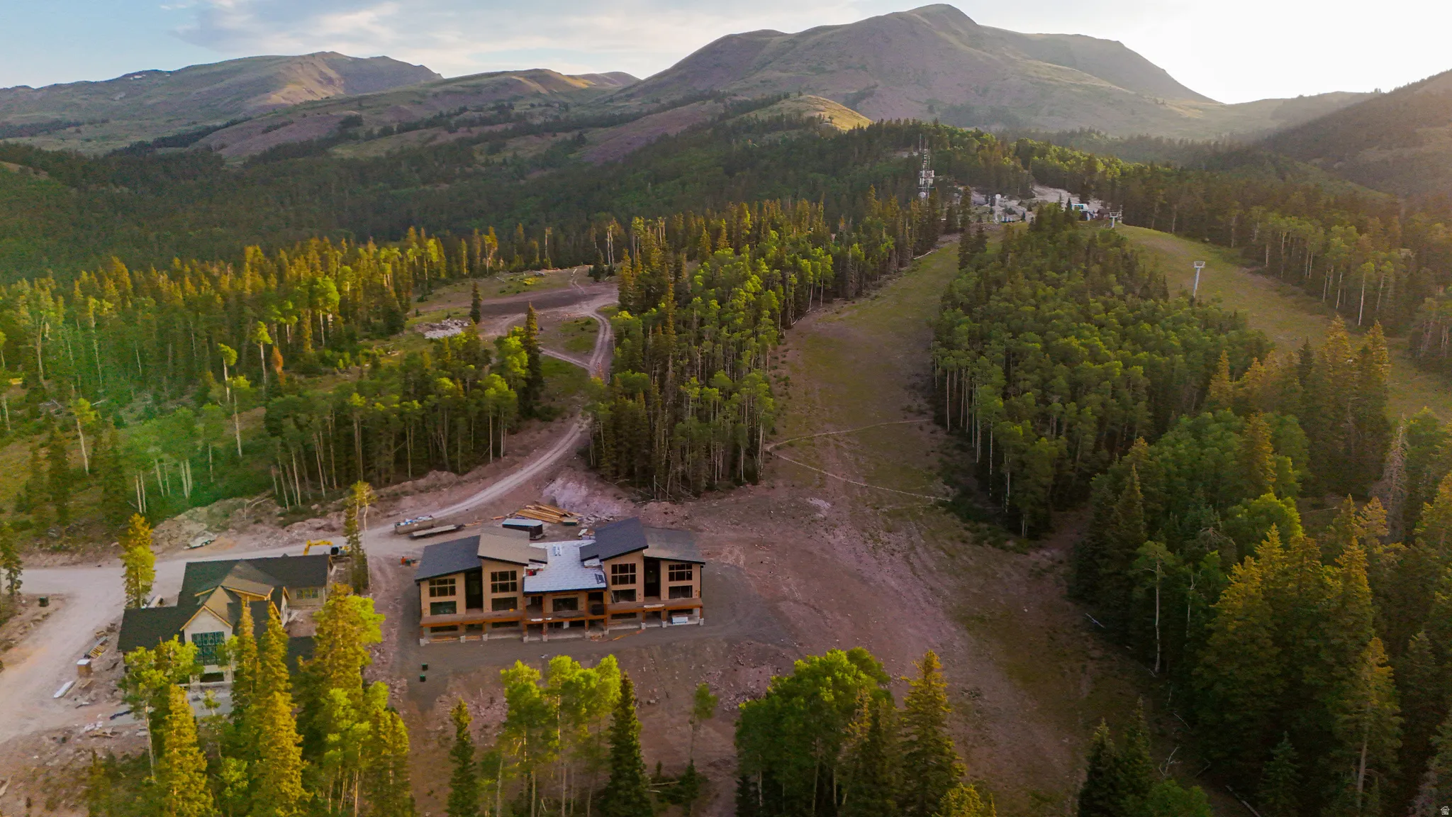 Contemporary property featuring multiple levels, expansive windows, and a mix of wood-finish and dark-toned siding
