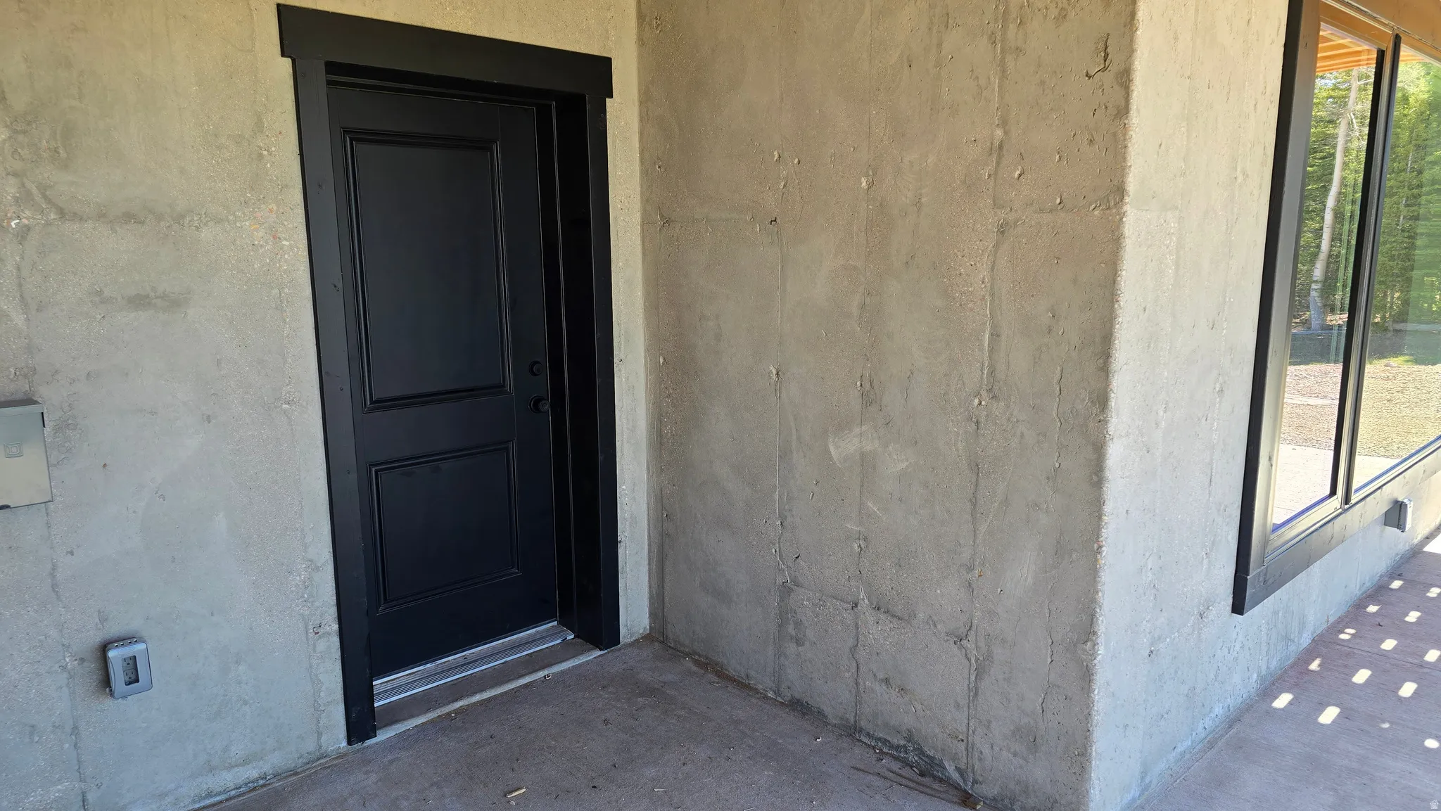 Black paneled entry door with contrasting black trim