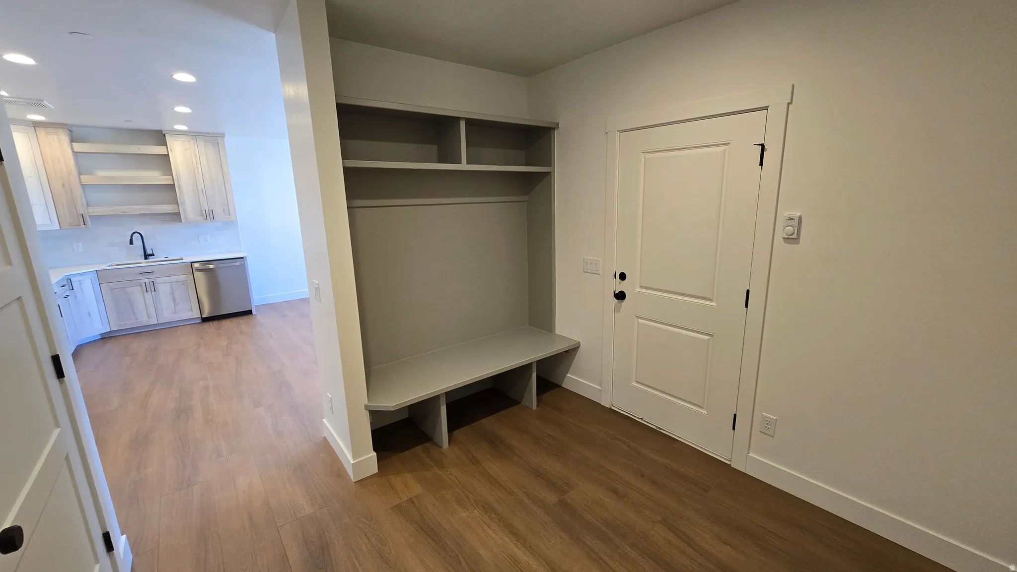 Entryway mudroom with built-in shelving and bench seating