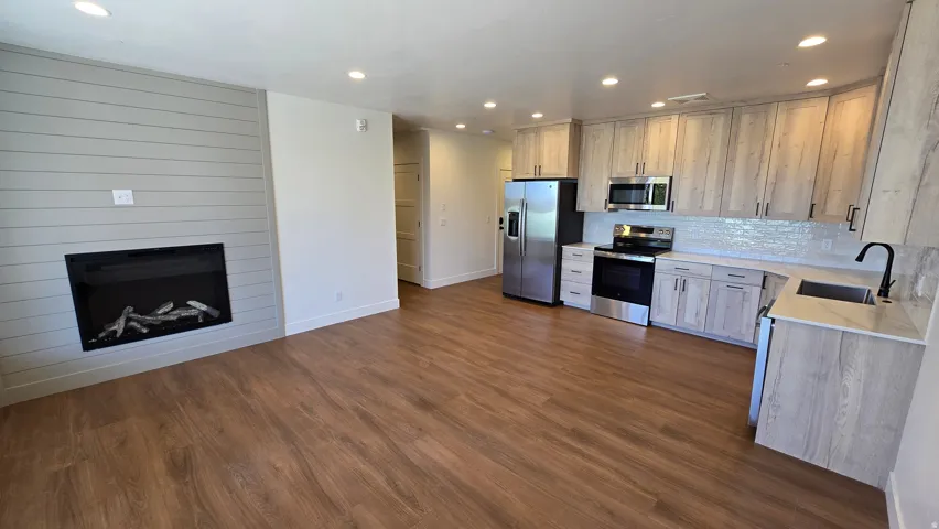 Open-concept living space featuring wood-finish flooring