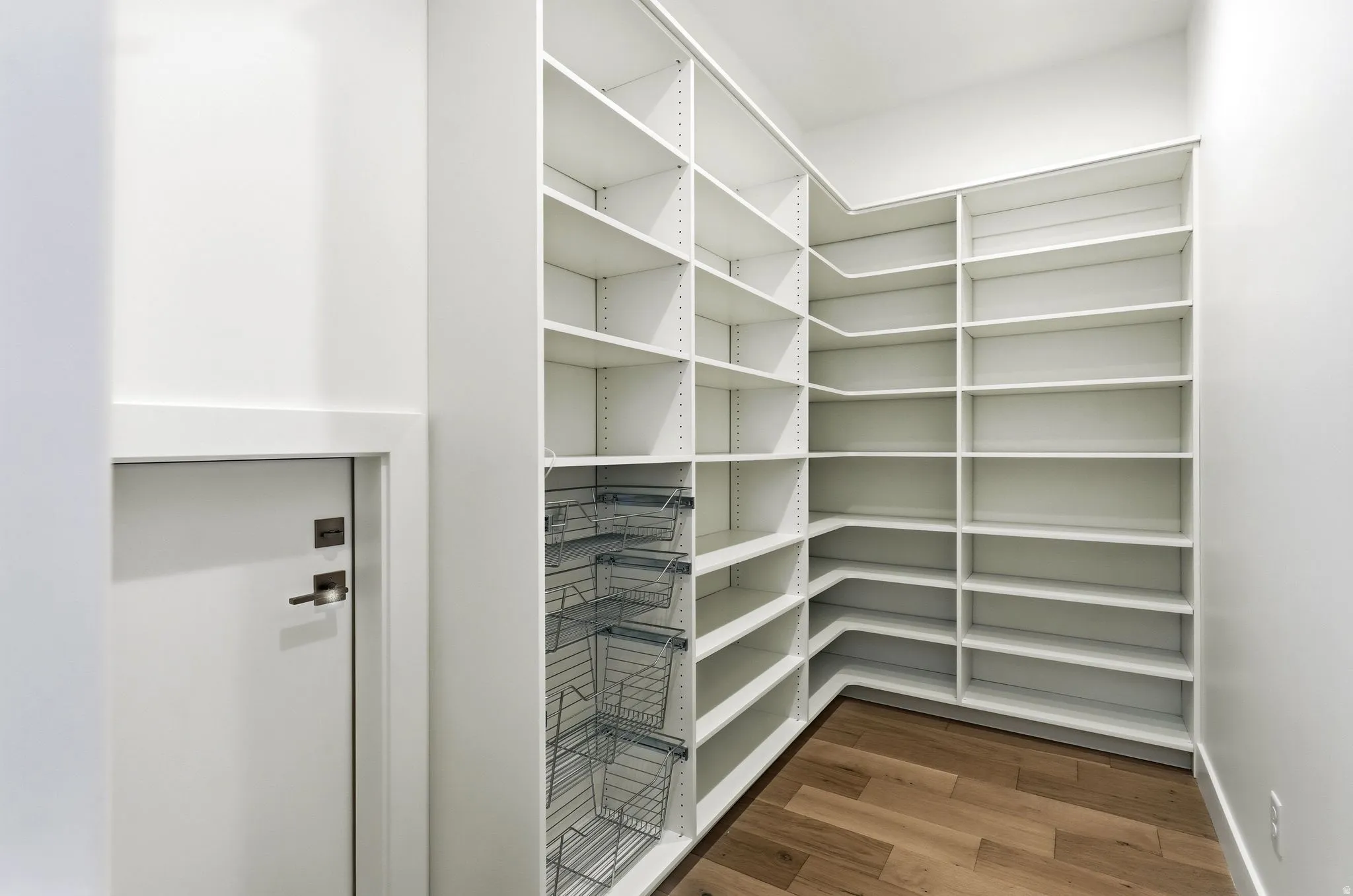 Custom-designed pantry featuring extensive white shelving
