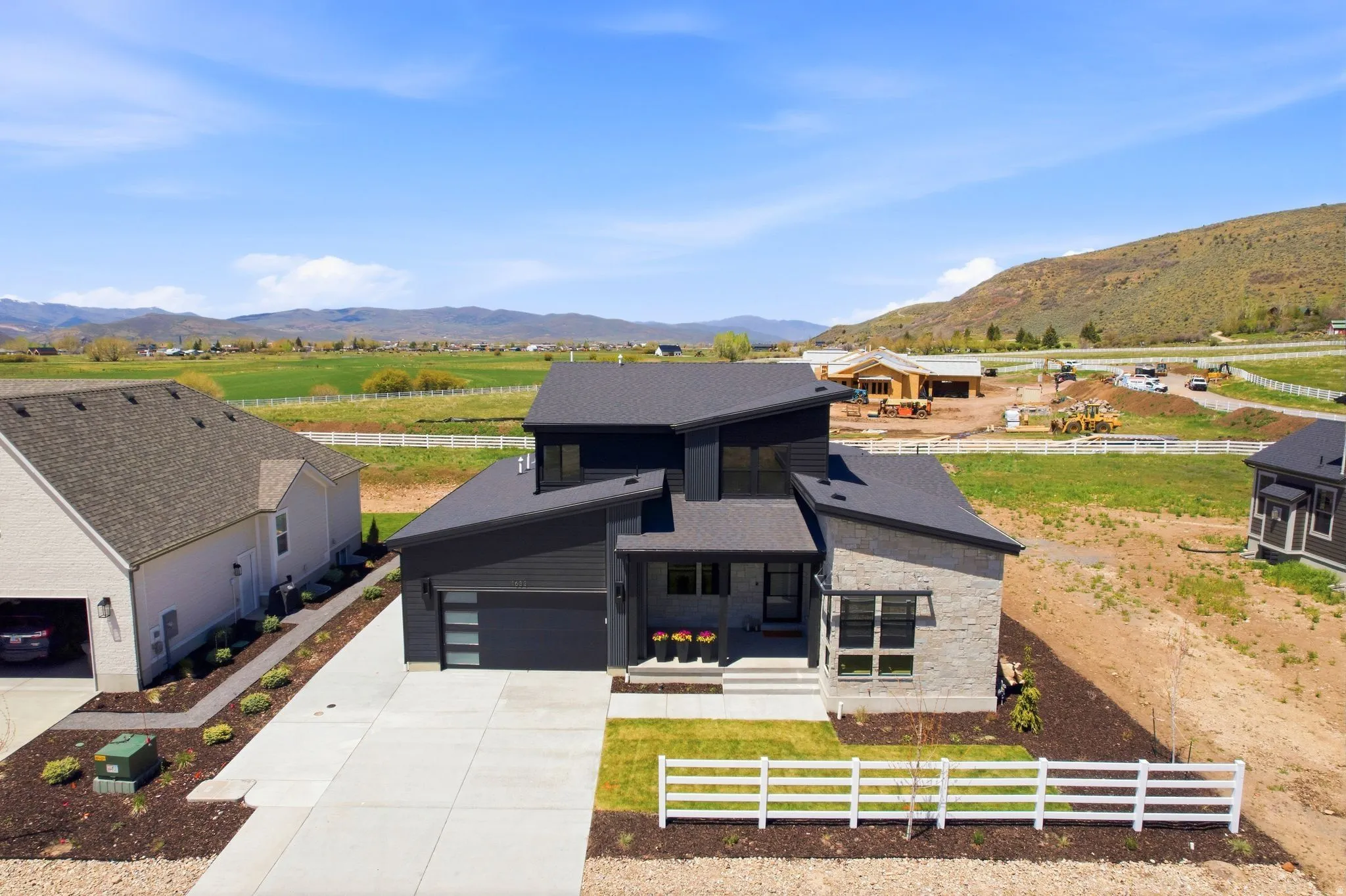 Contemporary residence featuring a dark gray facade and stone accents