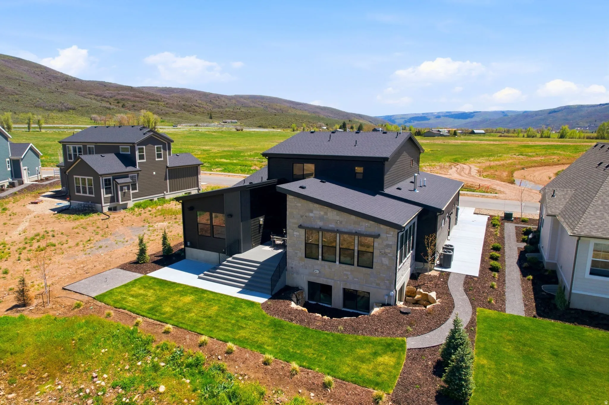 Contemporary architecture with stone and dark paneling accents