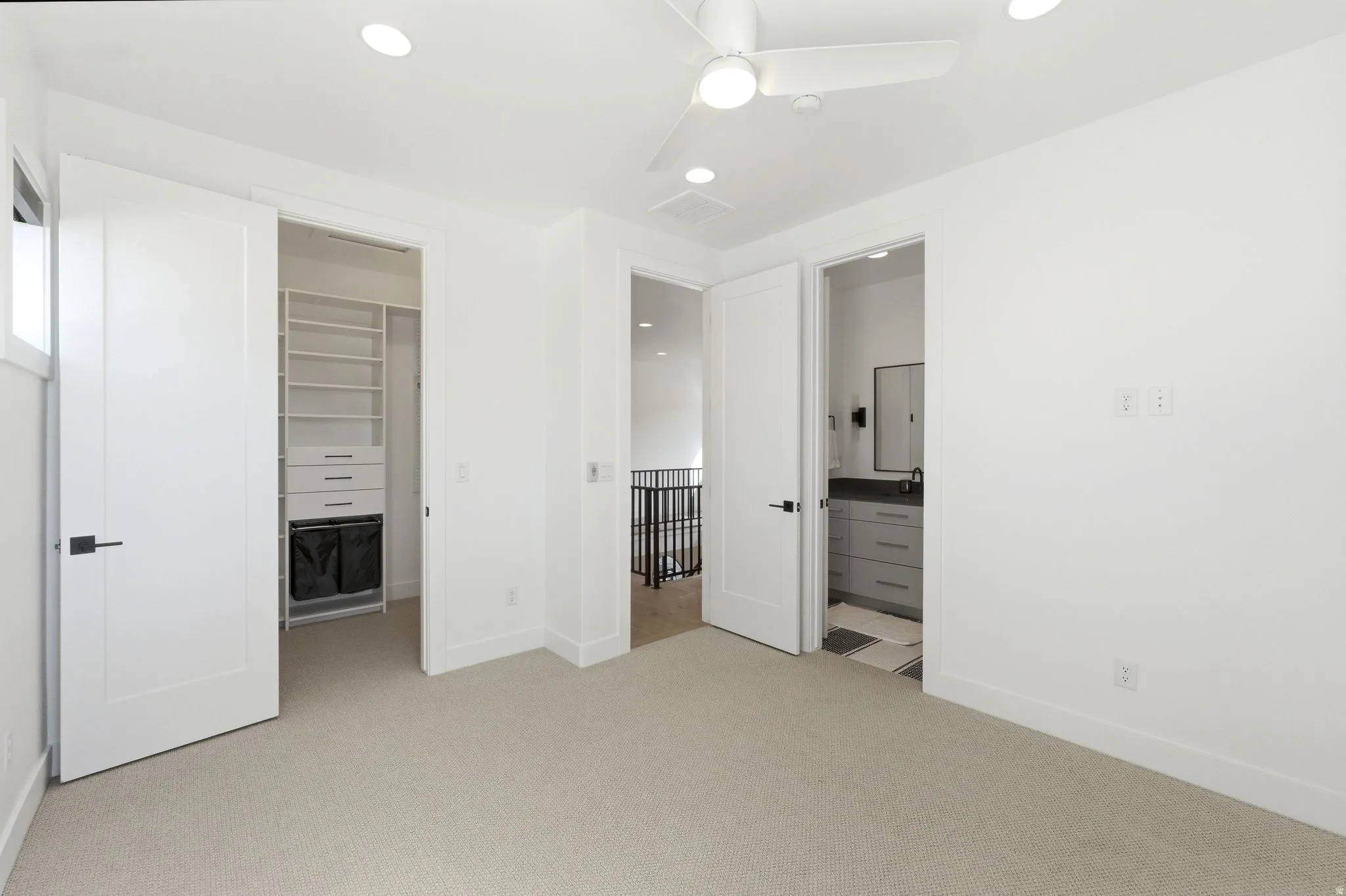 Carpeted room featuring a ceiling fan, recessed lighting, and a window