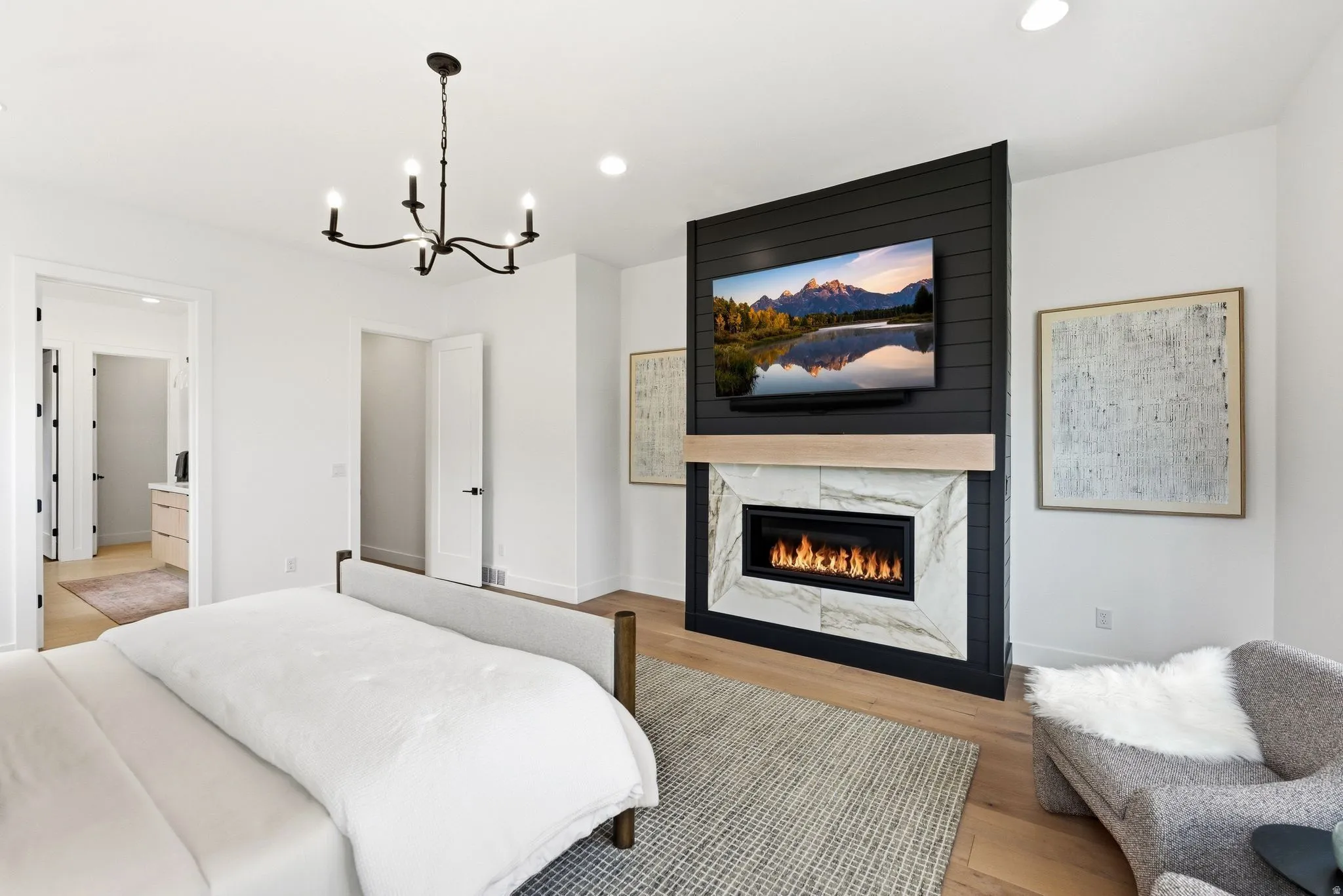 Accent wall with a linear fireplace featuring a stone surround and a light wood-finish mantel