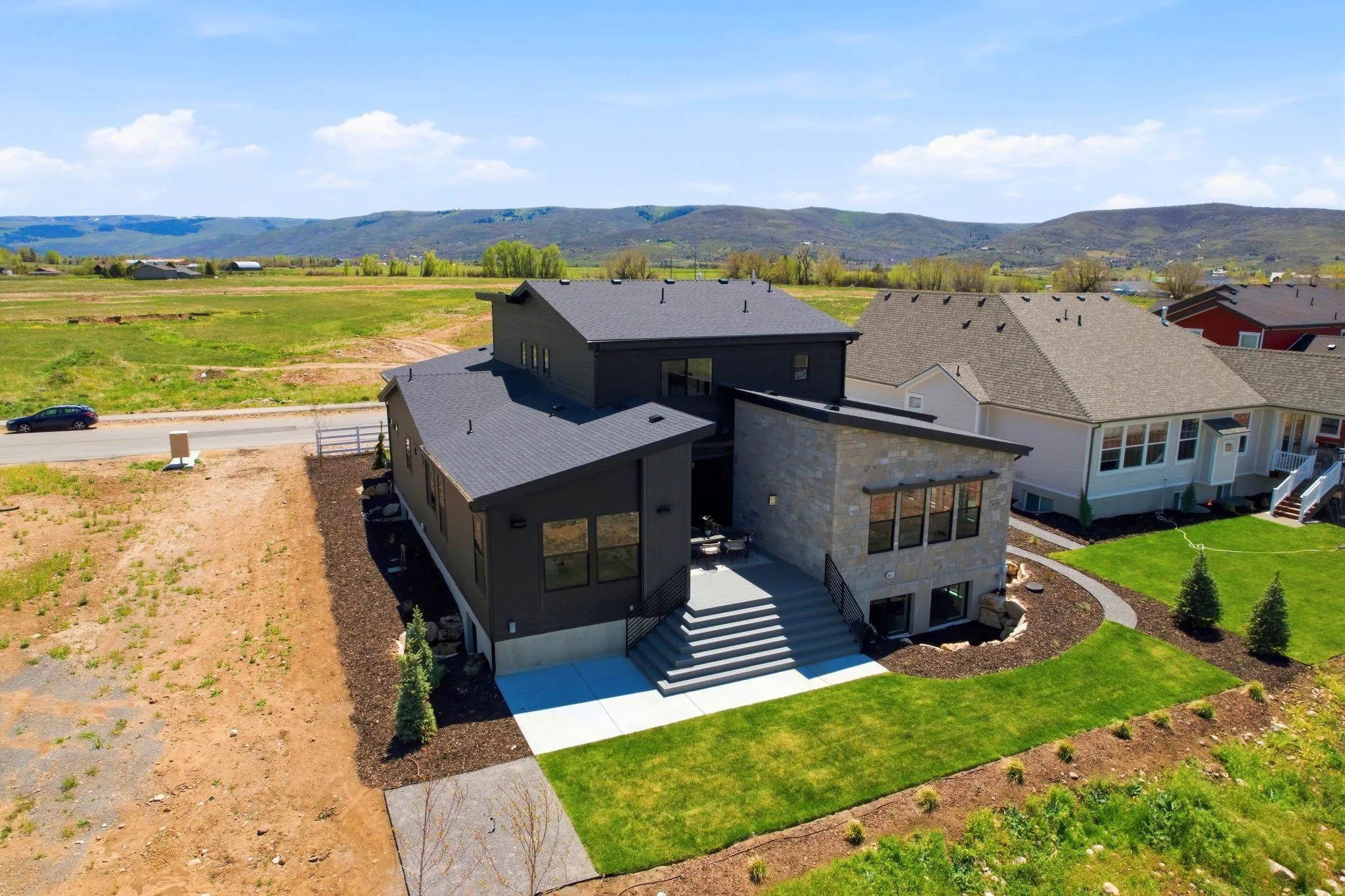 Modern architectural design featuring a multi-level structure with a dark-toned exterior