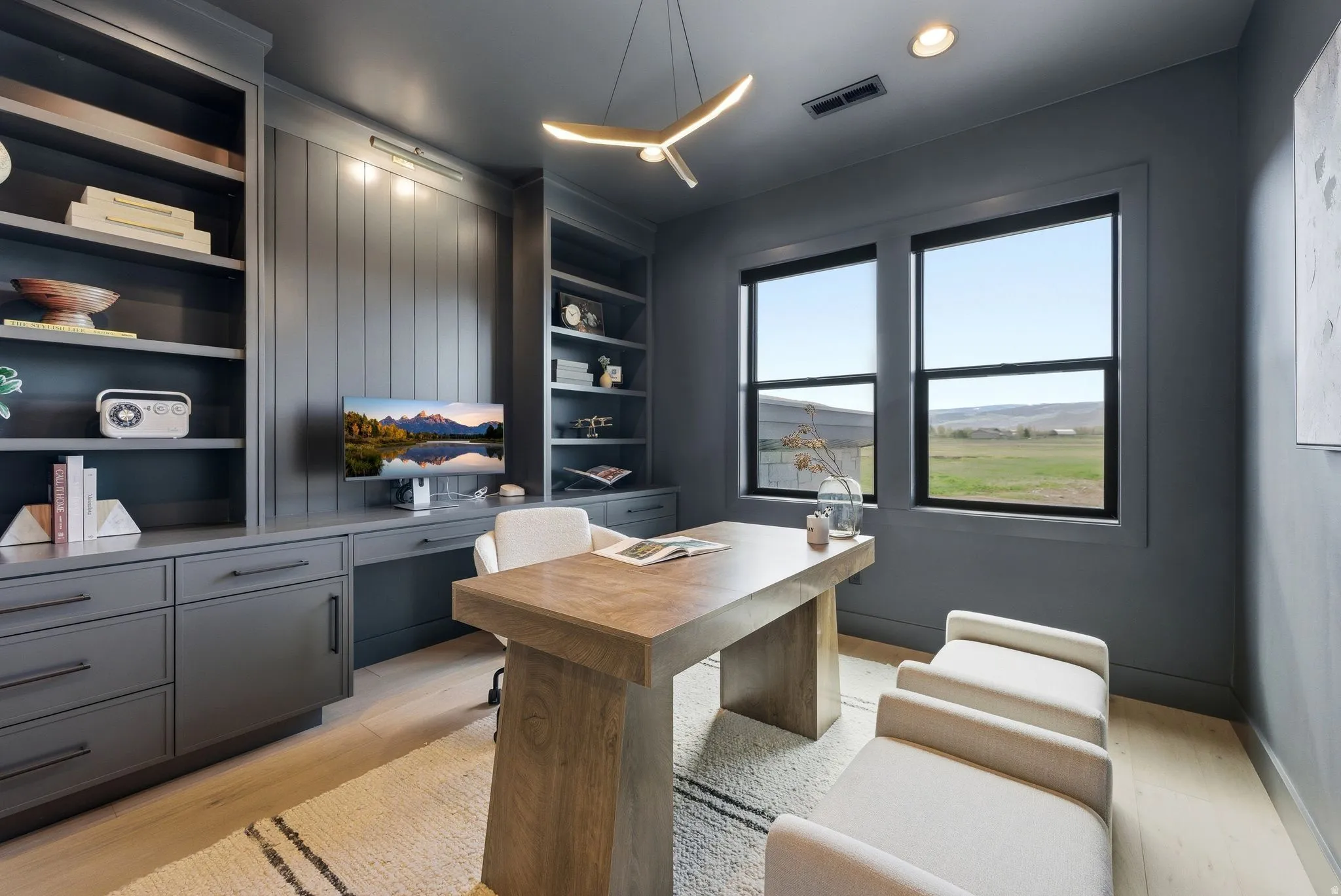 Dedicated office space featuring custom built-in shelving, integrated desk, and storage cabinetry
