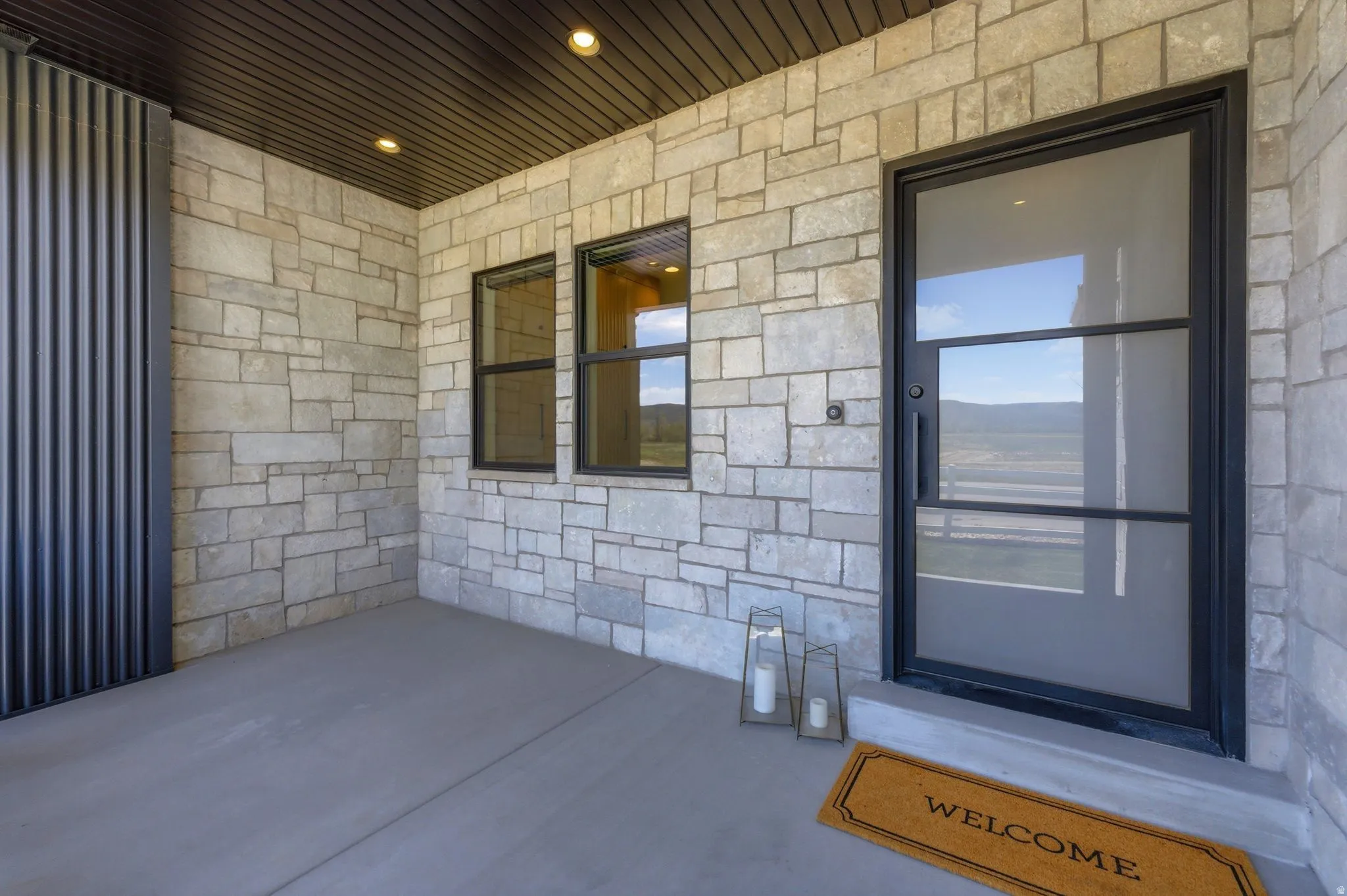 Stone veneer exterior with a corrugated metal accent panel