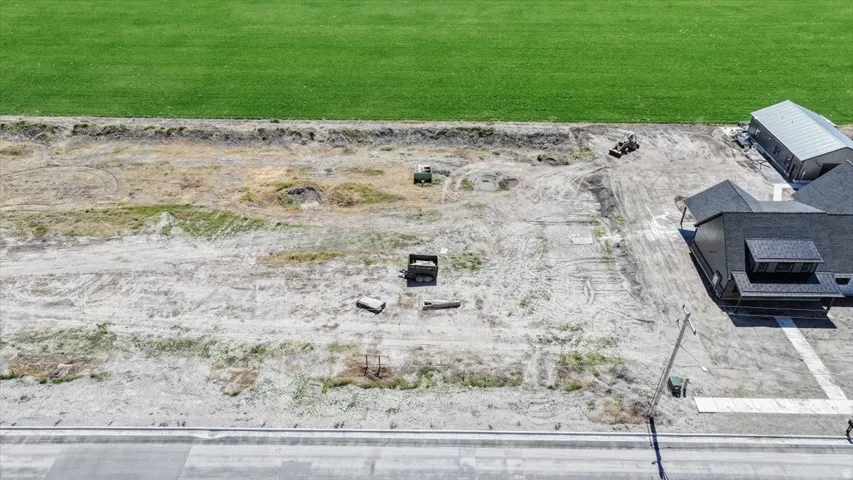 Expansive undeveloped lot featuring direct road frontage and a verdant green field border